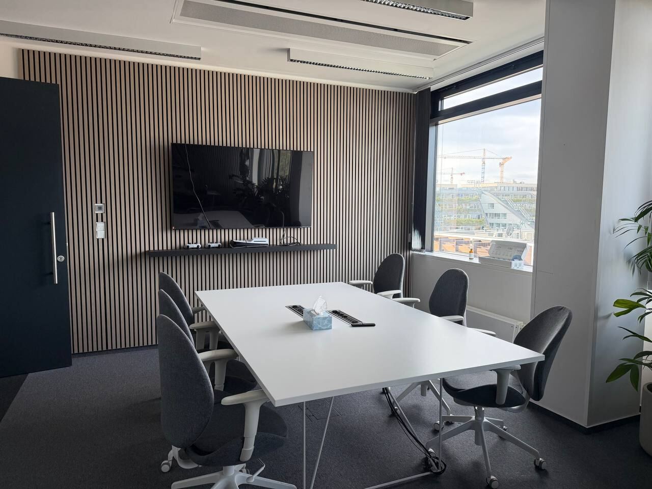Wider view of the meeting room with its door