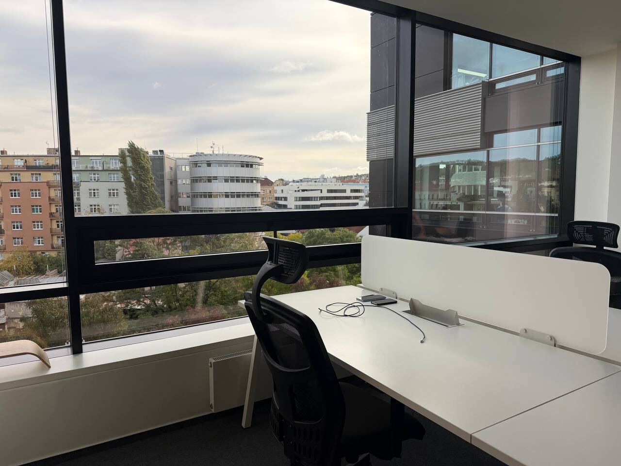 Work desk by a large window with a view over the city